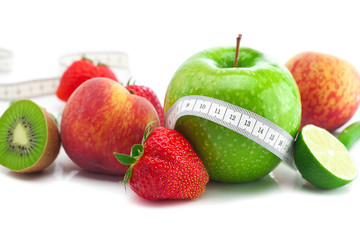 Fototapeta na wymiar big juicy red ripe strawberries,apple,lime,peach,kiwi and measu