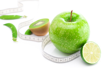 apple,lime,peas,kiwi and measure tape isolated on white