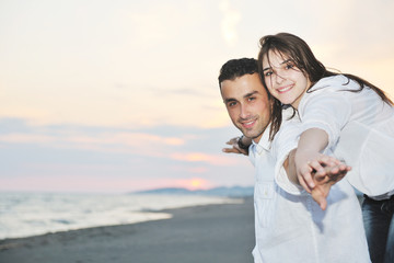 happy young couple have fun on beach