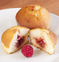 goden muffin with a raspberry