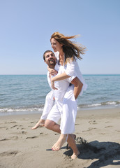Fototapeta na wymiar happy young couple have fun on beach