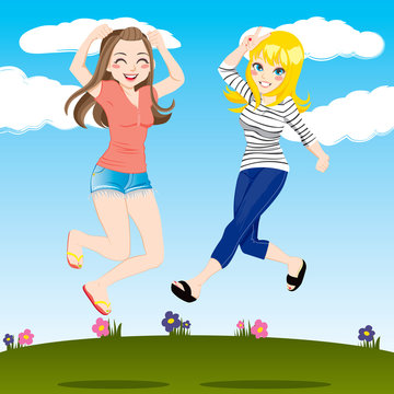Happy girls jumping on grass field