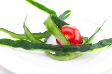 tomato and cucumber skin on a plate isolated on white