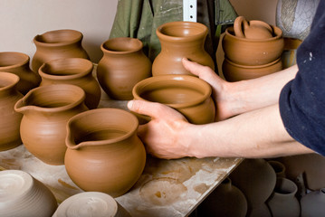 hands of a potter, creating an earthen jar