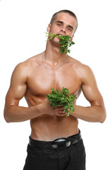 Muscle sexy wet naked young man eating the parsley