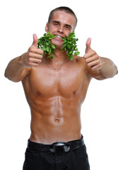 Muscle sexy wet naked young man eating the parsley