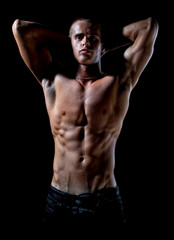 Fototapeta na wymiar Muscle sexy wet naked young man posing in studio