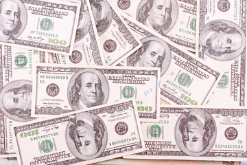 Bunch of hundred dollar bills with some marks.