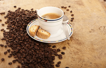 Coffe cup over coffee beans