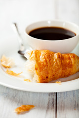 Croissant and a cup of black coffee