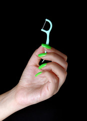 dental floss toothpick in woman hand