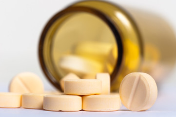Pills on isolated white background with bottle