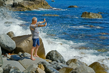 Man on stones at surf 7