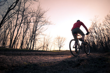 man biking at sunset