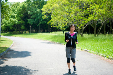 beautiful asian woman jogging in the park