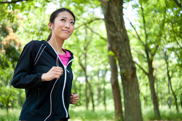 beautiful asian woman jogging in the park