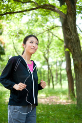 beautiful asian woman jogging in the park