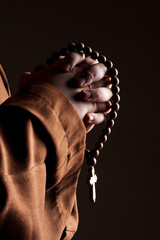 Monk with two hands clasped in prayer © Nomad_Soul