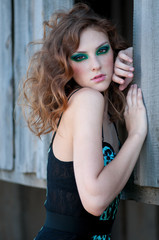 Fashion woman with green make-up at rural location