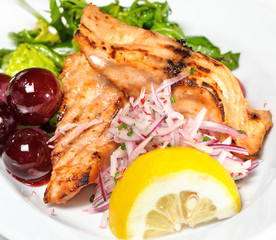 piece of grilled salmon, lettuce and lemon,grapes