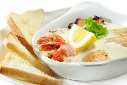cream soup with prawn,scallops and mushrooms,isolated on white
