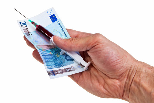Syringe with red liquid and 20 Euro banknote in male hand.