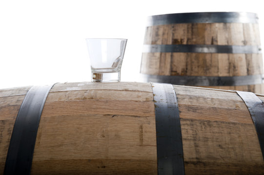whiskey glass on wooden barrel