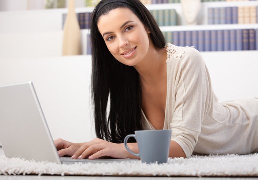 Attractive woman with laptop at home