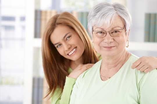 Portrait of elderly mother and daughter smiling
