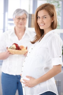 Attractive expectant mother smiling happily