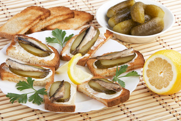 Sandwiches with sprats and ingredients to them