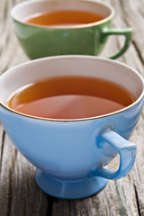 Two antiques cups with tea