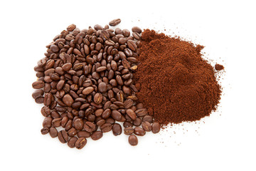 Pile of ground coffee and beans over white background