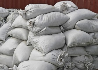 Fototapeta na wymiar Getting ready for the flood: Large pile of white sandbags