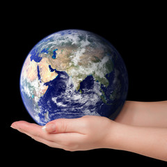 Woman holding in palms earth