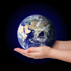 Woman holding in palms earth