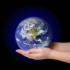 Woman holding in palms earth