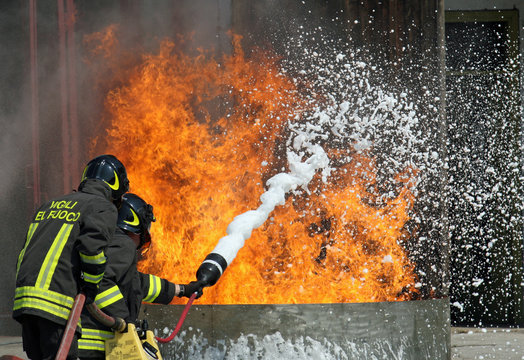 Firefighters extinguish a large fire with a fire extinguisher