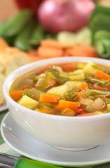 Fresh vegetable soup with ingredients in the back