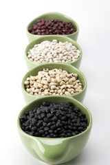 Assorted mixed dried beans in green ceramic dish