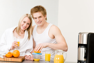 Obraz na płótnie Canvas Breakfast happy couple make orange juice morning