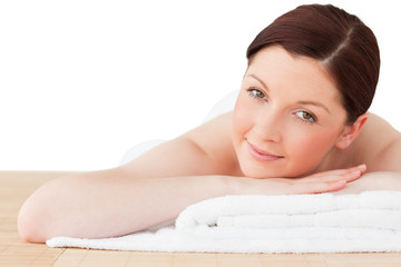 Young pretty red-haired woman posing while relaxing in a spa cen