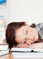 Beautiful red-haired girl having a rest while studying for an ex