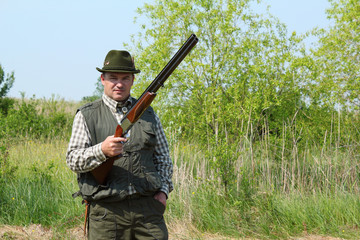 hunter posing with shotgun