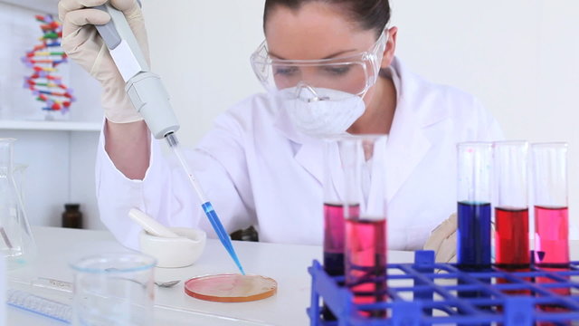 Female scientist carrying out an experiment