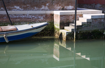 Fototapeta na wymiar Venicce - boat and staris by canal