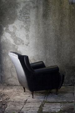 black armchair and grey wall