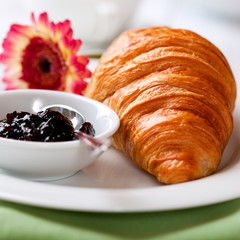 Closeup of croissant and blackberry jam
