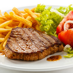 Grilled steak, French fries and vegetables