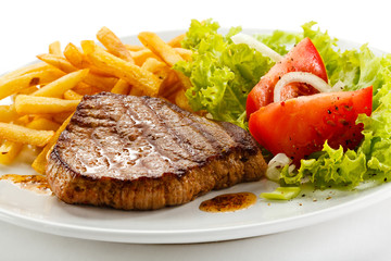 Grilled steak, French fries and vegetables